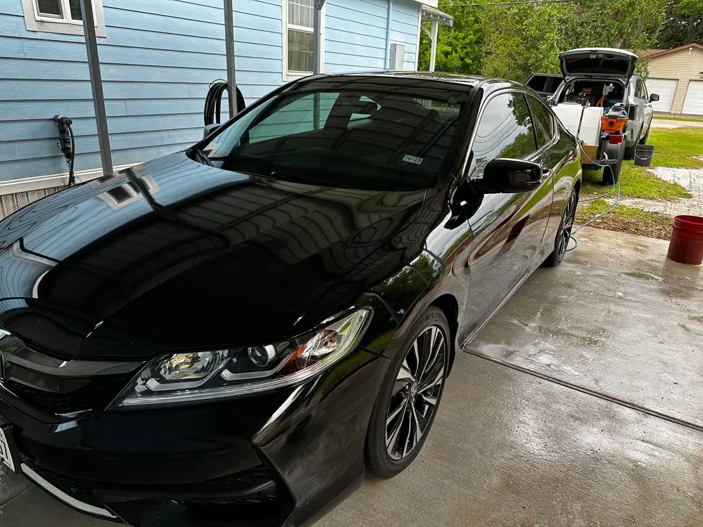 Mobile paint correction on a black Honda at a client's home