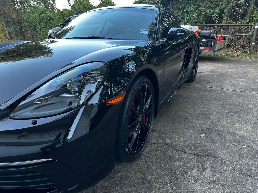 Auto detailing on a black Porsche
